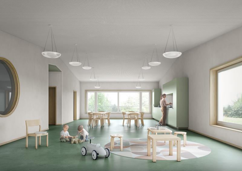 Kindergartenraum mit grünem Bodenbelag, Spielzeugen und hellen Hängeleuchten.