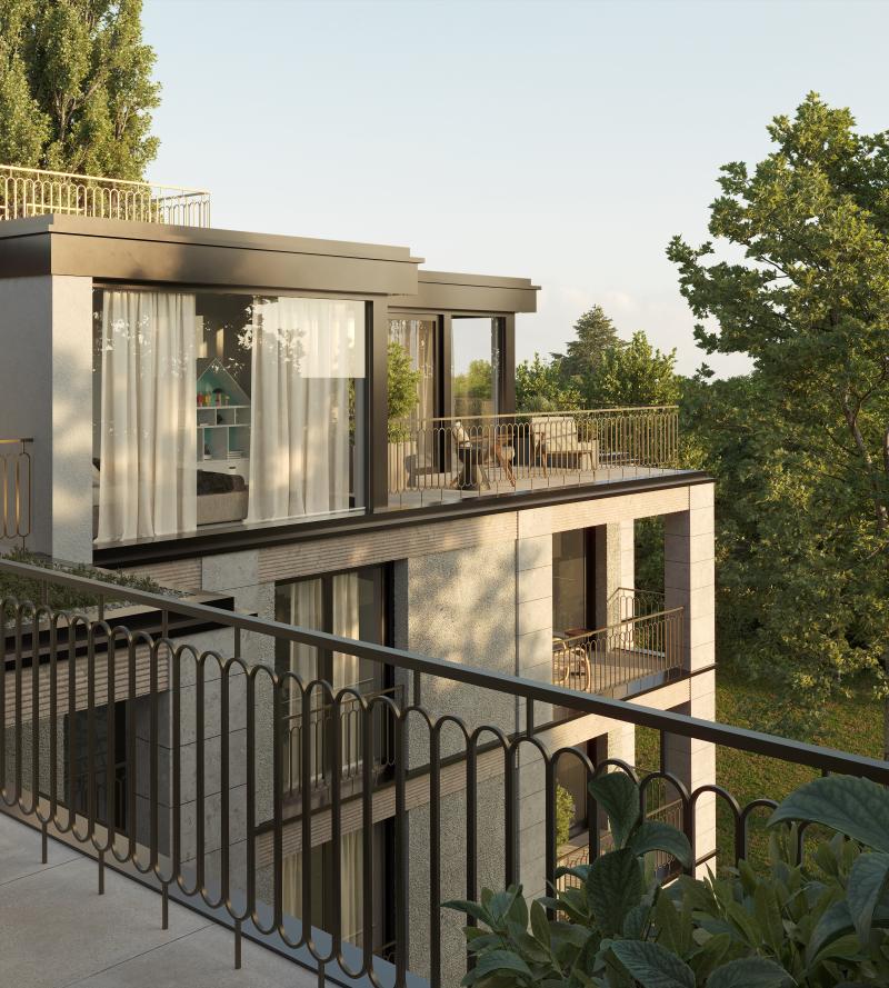 Mehrfamilienhaus mit Balkonen und großflächigen Fenstern in moderner Architektur.