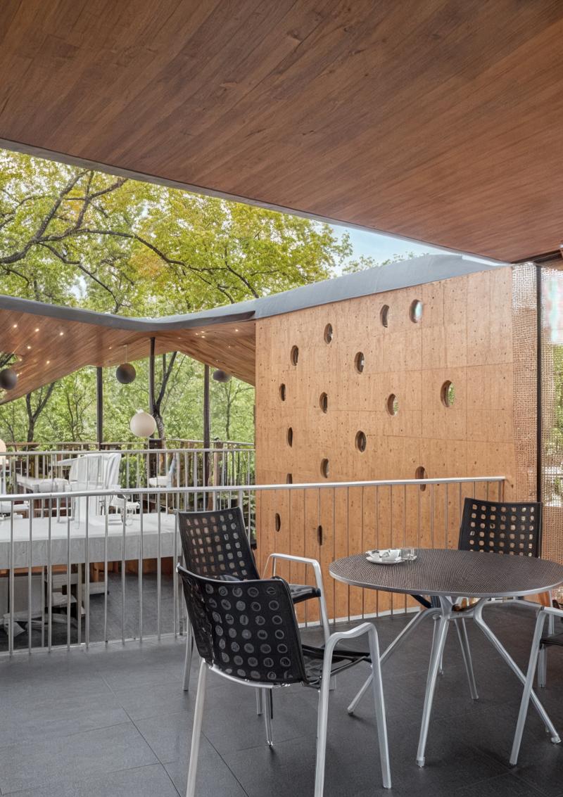 Überdachte Terrasse mit Esstisch und Stühlen an einer Doppelhaus-Villa am Baggersee.